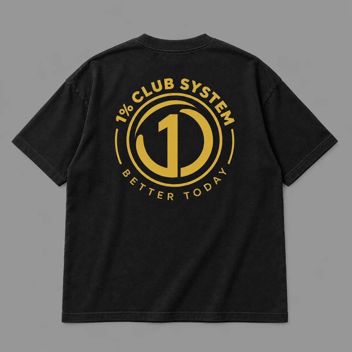 Black oversized tee concept with the circular gold 1% Club System back print
